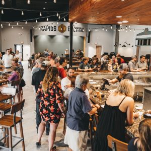 People in the taproom with the stage in the background